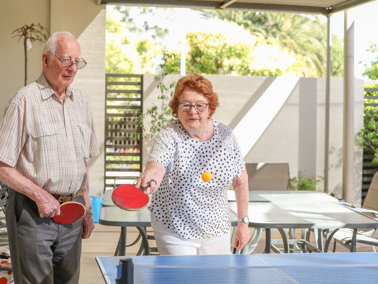 Two residents enjoying a game of table tennis